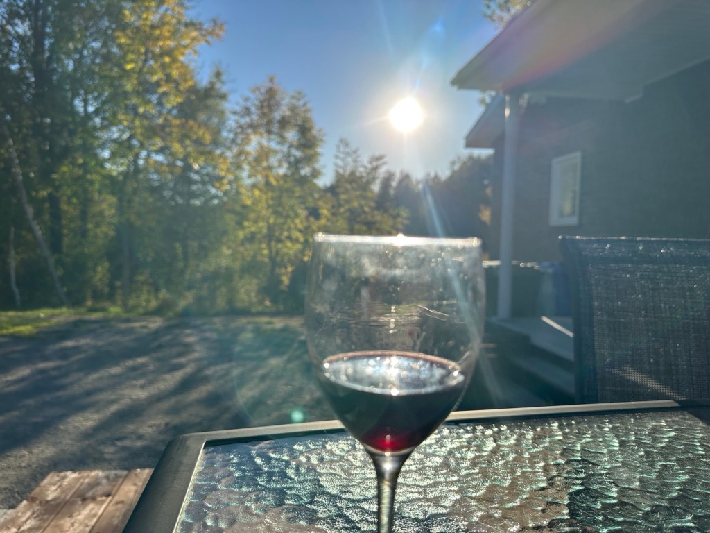 Glass of wine on a table at sunset